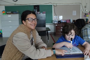 Instructor smiling while working with student