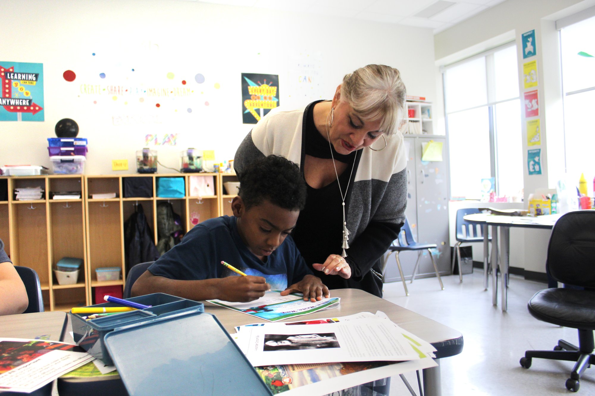 Teacher working with student on seat work 3